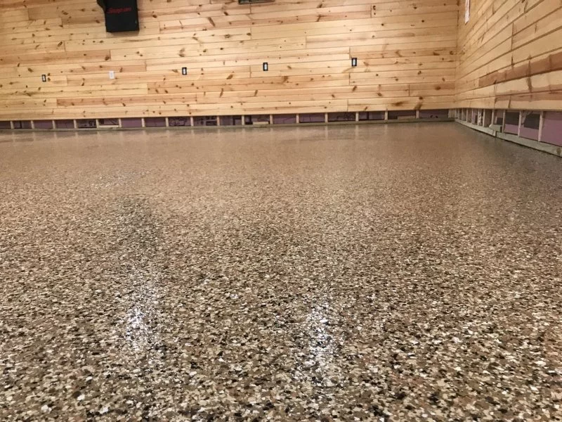 basement floor with epoxy coating and wooden wall