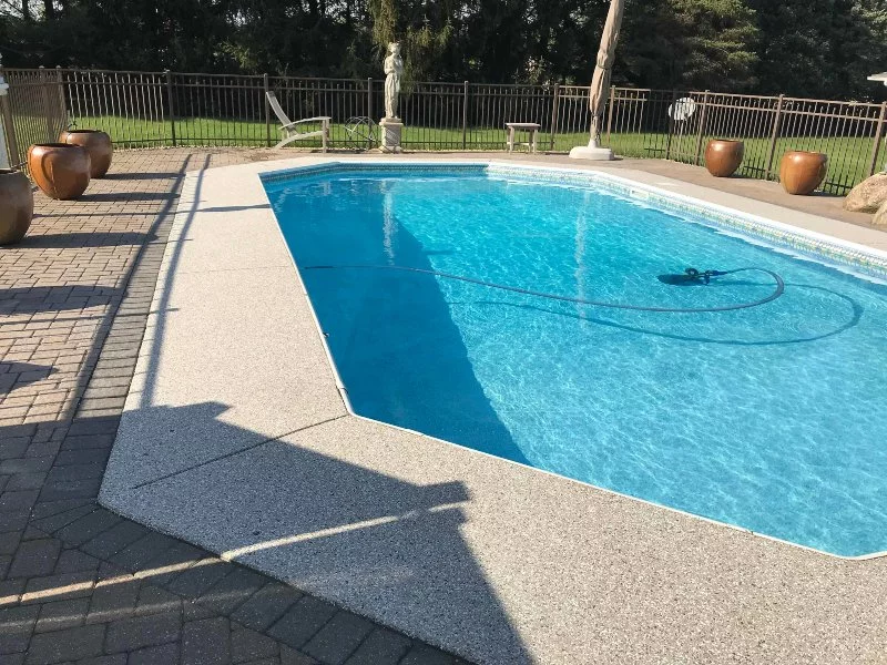 pool and pool deck after epoxy coating with brown flower pots