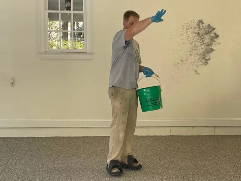 floor installation professional applying epoxy coating